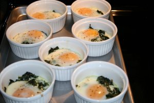 Кулинарный рецепт: Яйца со сливками, запеченные на пару: Яйца в порционных мисках, залитые сливками и запеченные на пару с петрушкой